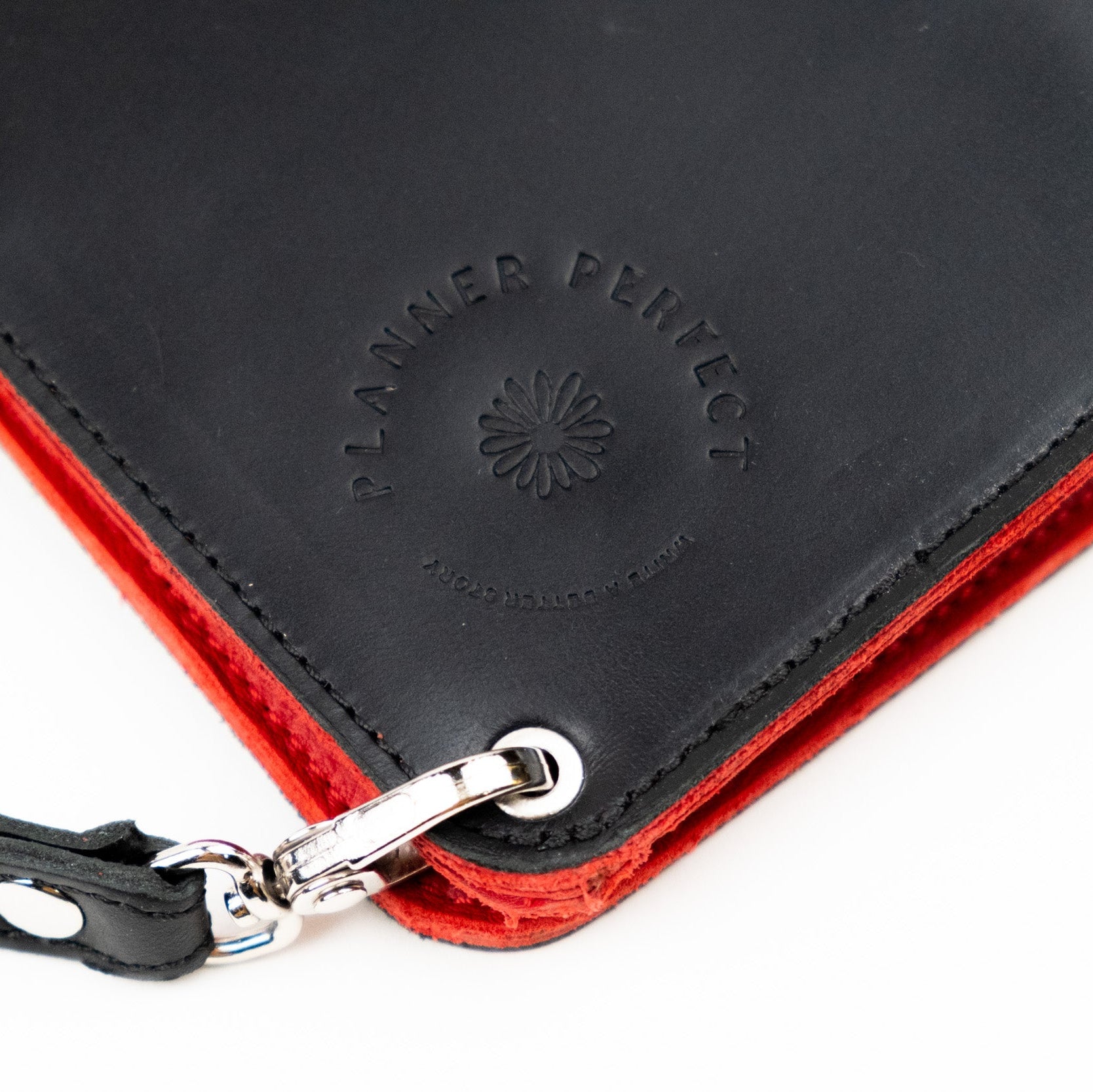 Black and red wallet with 'Planned Perfect' branding on a white background